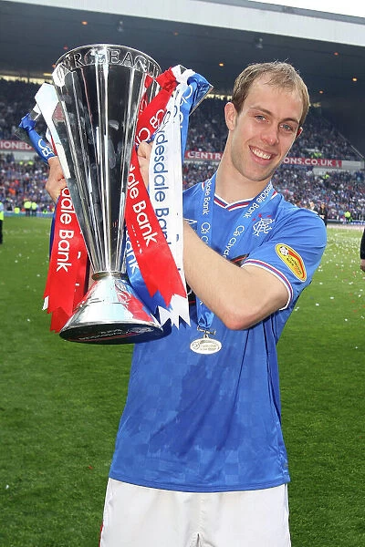 Rangers Football Club: Steven Whittaker's Triumphant Moment with the SPL Trophy at Ibrox Stadium