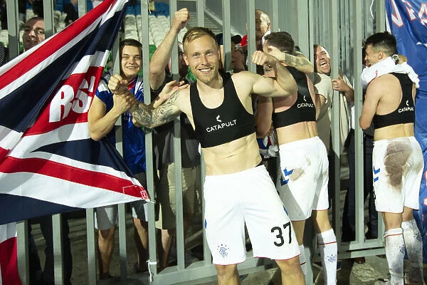 Rangers Football Club's Europa League Triumph: Scott Arfield Embraces Adoring Fans at Neftyanik Stadium