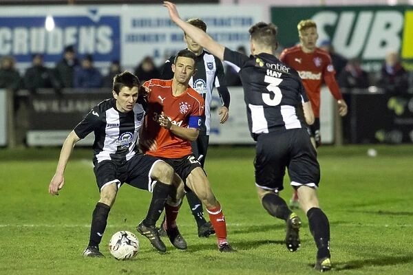 Rangers Jason Holt Fights for Ball in Intense Scottish Cup Clash at Fraserburgh's Bellslea Park