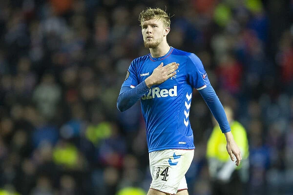 Rangers Joe Worrall Emotional Moment: Touching the Badge after Europa League Victory at Ibrox Stadium