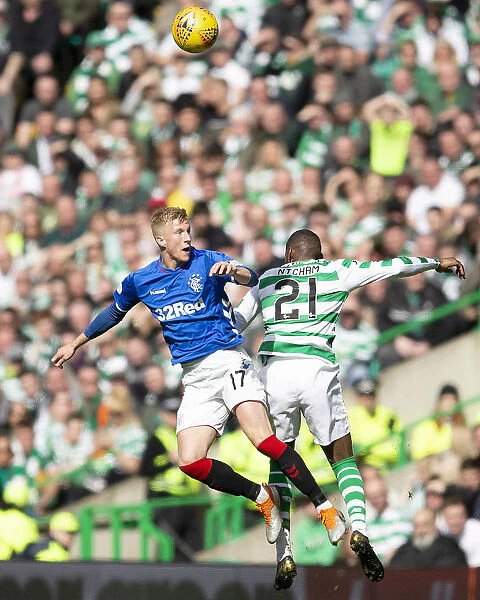 Rangers McCrorie Leaps Against Ntcham in Intense Celtic Showdown