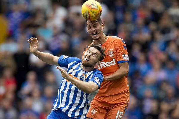 Rangers Nikola Katic Soars Over Kilmarnock's Stephen O'Donnell in Betfred Cup Showdown at Rugby Park