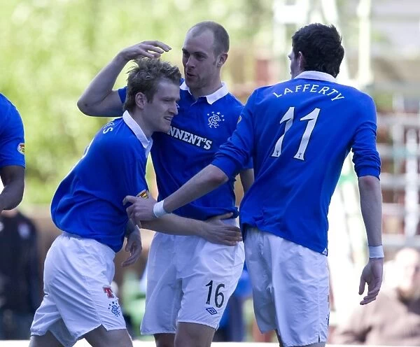 Rangers Triumphant Three: Davis, Whittaker, and Lafferty Celebrate Goals in Motherwell's Fir Park (5-0 Scottish Premier League Victory)
