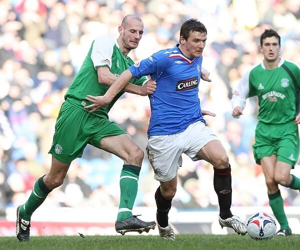 Rangers vs. Hibernian: A Fierce Battle for the Ball in the Scottish Cup Fifth Round Replay at Ibrox - Rangers Lead 1-0