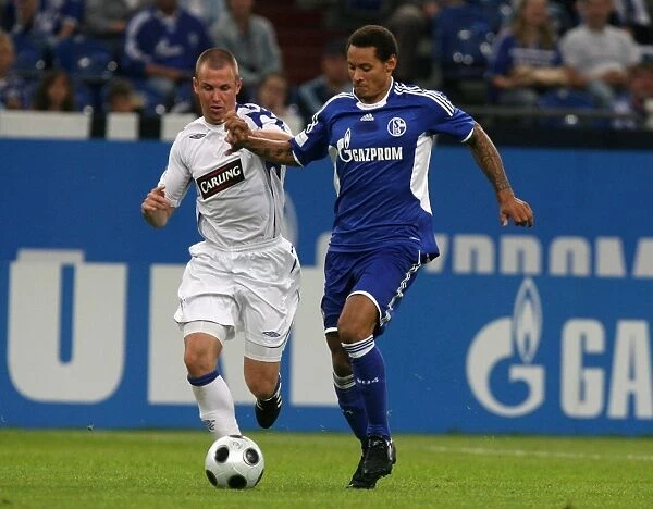 Rangers vs. Schalke 04: A Tight Battle for the Ball - Kenny Miller vs. Jermaine Jones (1-0 in Favor of Schalke 04)
