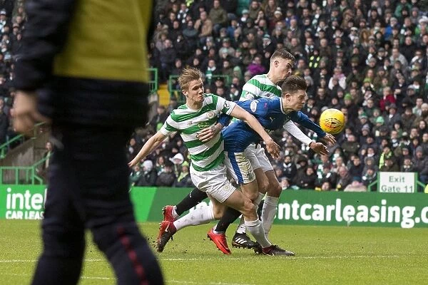 Rangers Windass Sandwiched by Celtic Defenders Ajer and Lustig in Intense Premiership Clash