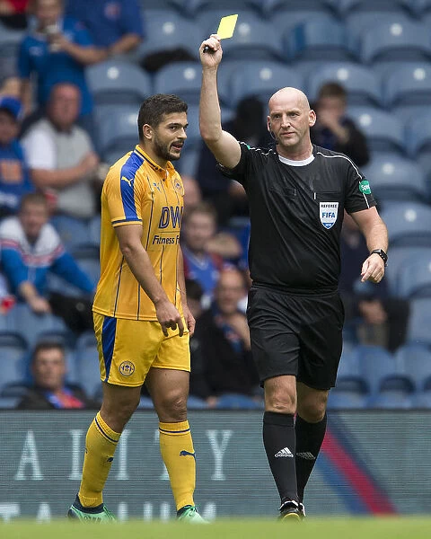 Referee Bobby Madden Shows Yellow Card to Samy Morsy during Rangers vs Wigan Athletic Match at Ibrox Stadium