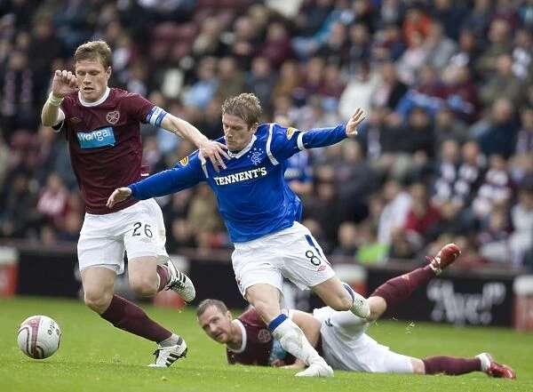 Steven Davis vs Marius Zaliukas: Intense Clash between Rangers and Heart of Midlothian in Scottish Premier League