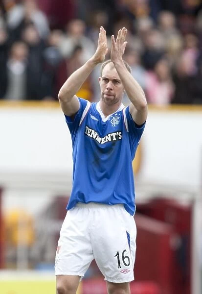 Steven Whittaker's Triumphant Applause: Rangers Victory Over Motherwell in the Scottish Premier League (2-1)