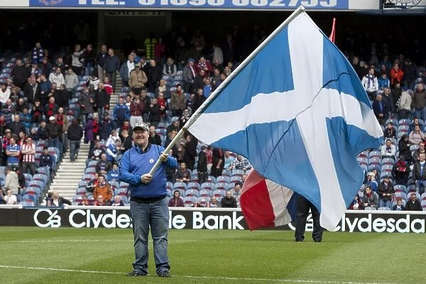 Triumphant Rangers: Flag-Bearing Supporter Celebrates 3-1 Victory over St. Mirren at Murray Park