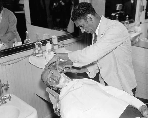 SENATE BARBER SHOP, 1936. Senator Guy Howard receiving a haircut and a shave