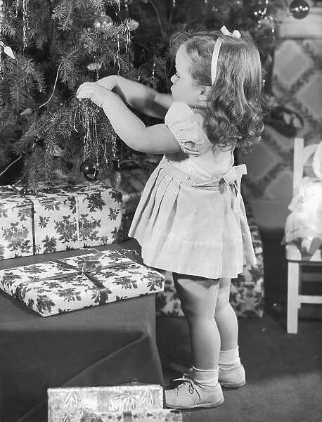 Little girl decorating Christmas tree
