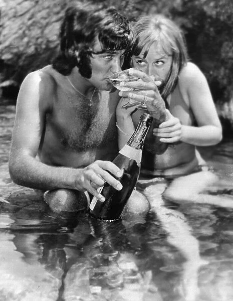 The champagne lifestyle for football star George Best seen here sipping Champagne with