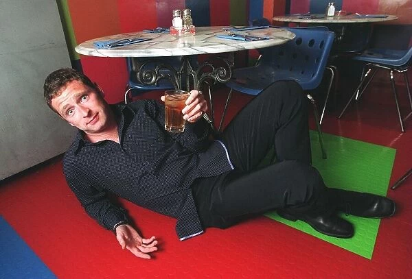 Mark Wogan son of Terry Wogan under the table with his apple juice