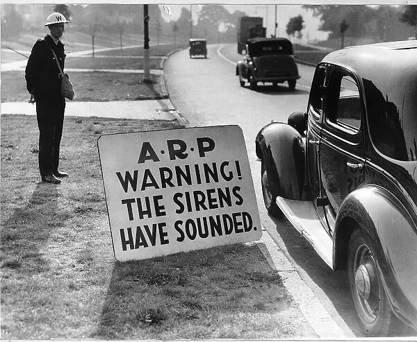 WW2 Air raid warden by road side Sept 40 warning notice for road users