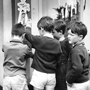 Boys using bubble gum machine, Balham, SW London