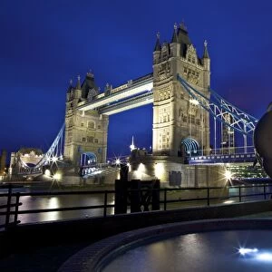 Girl With A Dolphin, statue by David Wynne, illuminated at night in front of Tower Bridge, London, England, United Kingdom, Europe