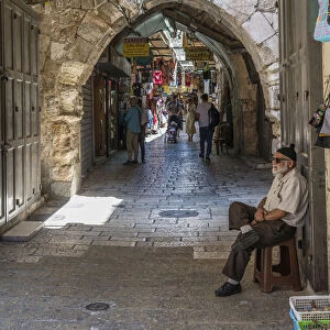 A shopkeeper minds his shop in the Old City of Jerusalem