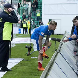 Rangers Jason Cummings: A Heartfelt Gift to Fans - Handing Over His Boots During the Hibernian Clash (Scottish Premiership 2021)