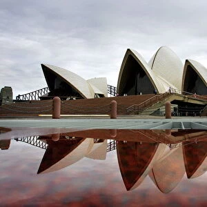 Sydneys landmark Opera House is reflected in a pool of rain water March 31, 2005
