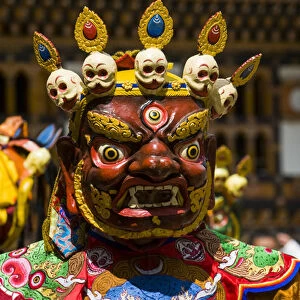 Costumed dancers at religious festivity with many visitors, Paro Tsechu, Bhutan