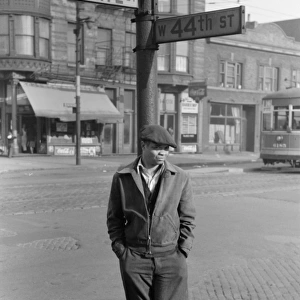 CHICAGO, 1941. Man standing at the corner of State and 44th Streets in Chicago, Illinois
