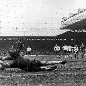 ENGLAND: SOCCER GAME, 1973. Pat Jennings of Tottenham Hotspur blocks a penalty kick by Tommy Smith of Liverpool during a soccer game, 31 March 1973