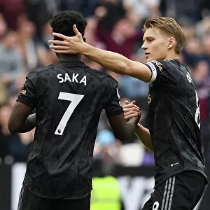 Agonizing Moment: Odegaard Consoles Saka After Missed Penalty in West Ham vs. Arsenal Clash