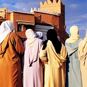 Morocco, Marrakesh, Djemaa El Fna, group of women, rear view