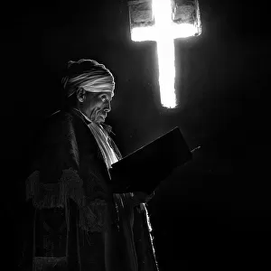 The priest, the book and the cross of light