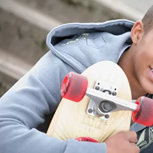 A Boy With A Skateboard; Oregon, Usa