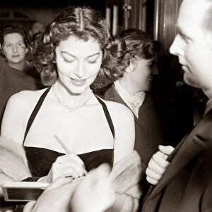 Ava Gardner signing autographs at a Midnight Matinee at the Colliseum, December 1951