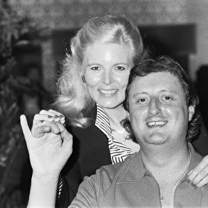 British dart player Eric Bristow poses with Maureen Flowers at the Embassy World
