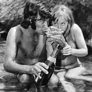 The champagne lifestyle for football star George Best seen here sipping Champagne with