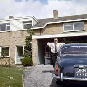 Chelsea manager Tommy Docherty at home with his car on the driveway May 1967