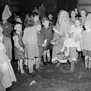 Father Christmas talking too the children at the yearly Daily Mirror Christmas Childrens