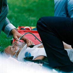 Lester Piggott receives treatment after falling from Coffe n Cream at Goodwood racecourse