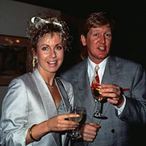 Mike Smith DJ disc jockey TV presenter with Sarah Greene holding glasses of champagne