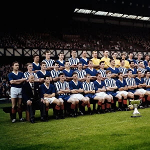 Rangers team 1961-62 line-up in front of main stand at Ibrox Park arms with cup trophys